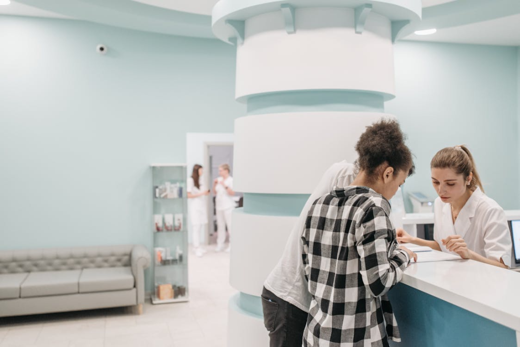 A couple looking at documents at reception of a medical center