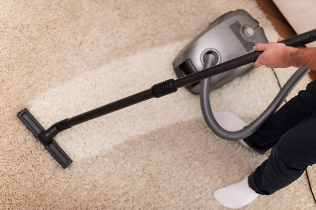 A person cleaning a carpet