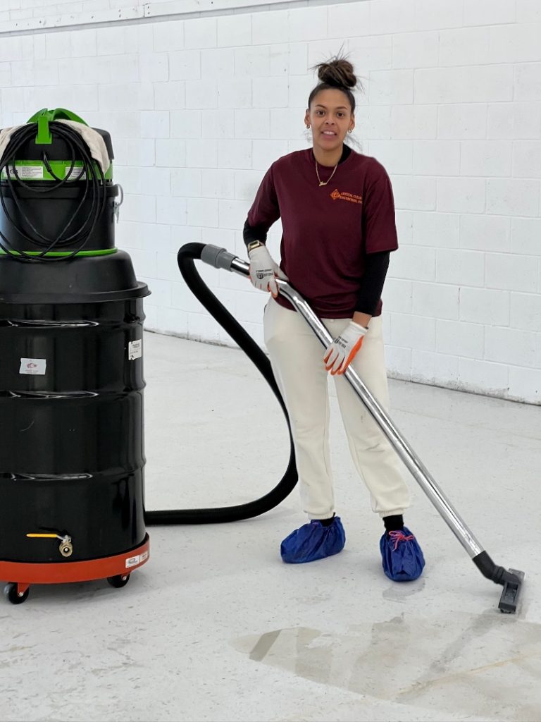 A woman cleaning with a large commercial machine