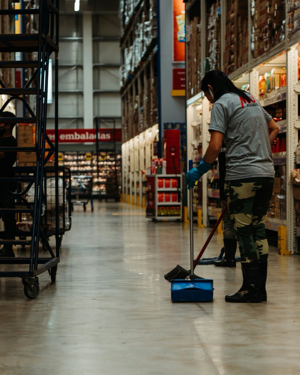 Professional warehouse sanitation team performing distribution center cleaning