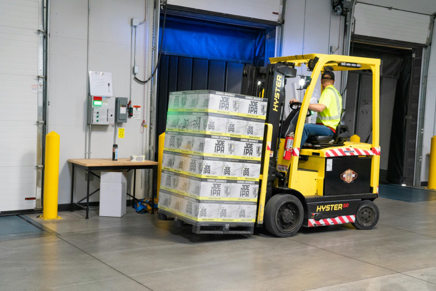 Warehouse floor maintained by an industrial cleaning team for safety and efficiency